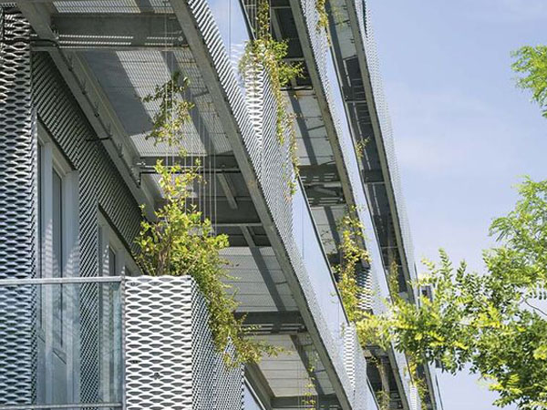 Perforated metal sheets with welded frame are installed as stair armrest.